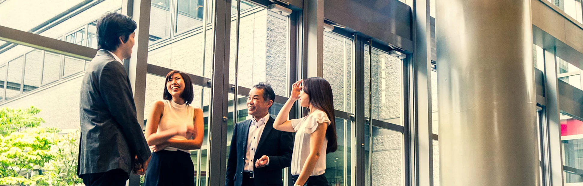 A group of business people gathered at the top of a flight of stairs