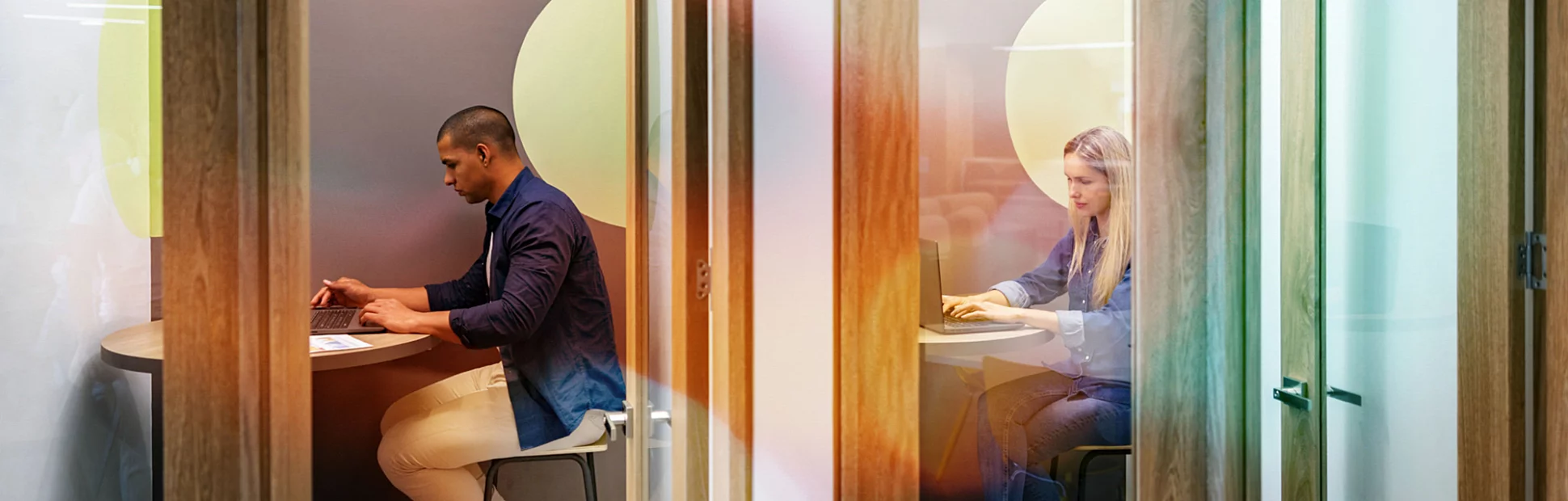 Business people working in private cubicles at a coworking office