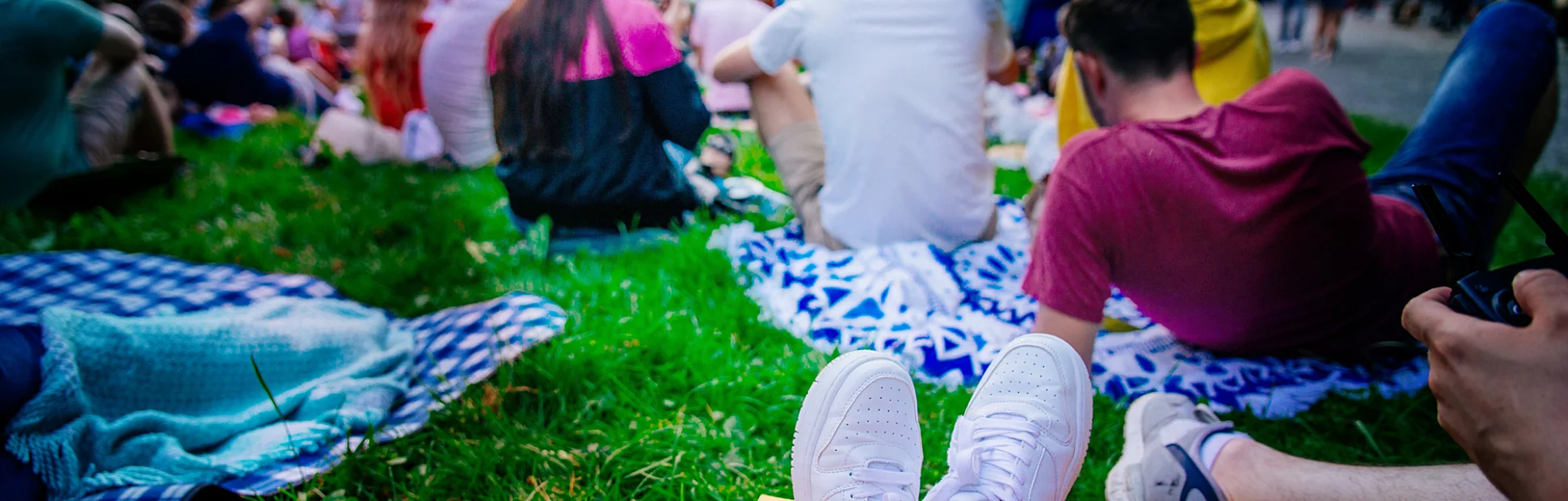 People watching movie in open air cinema in city park