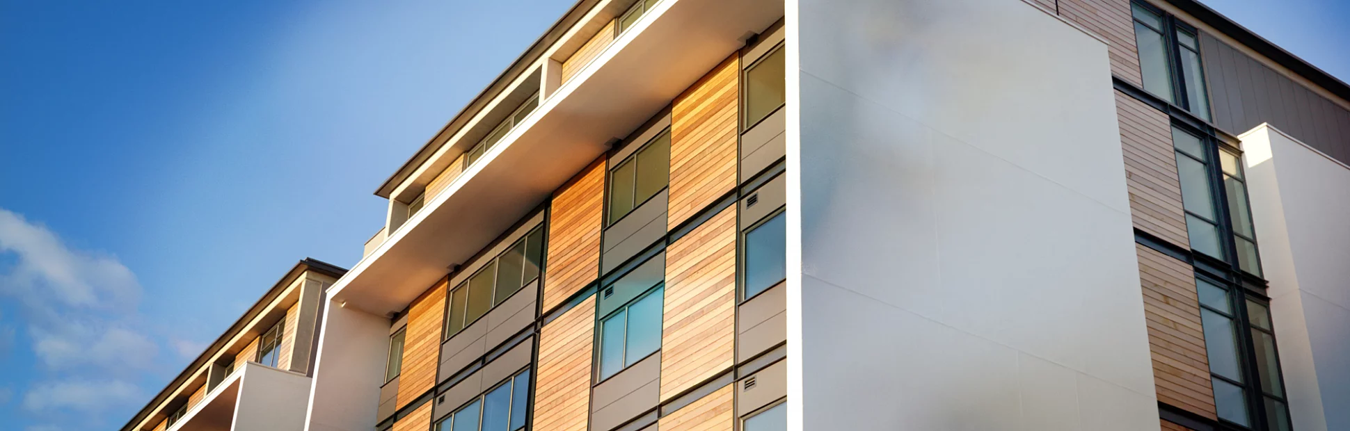 Residential Apartment with wood panels and blue clear sky