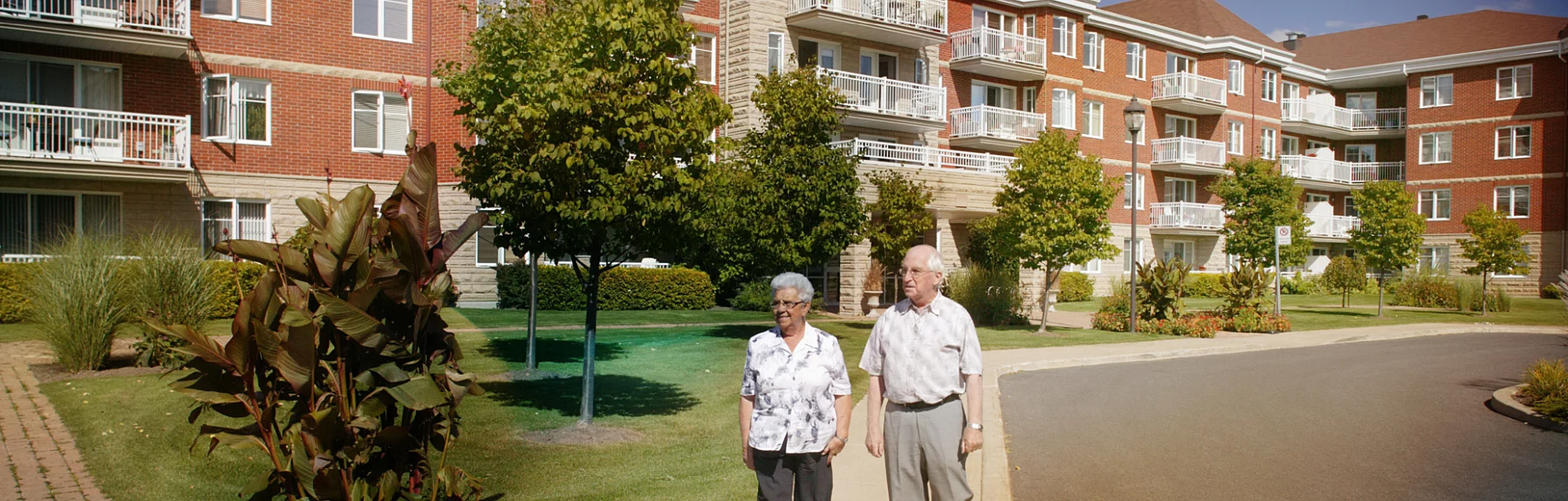 senior couple taking a walk outside apartment community