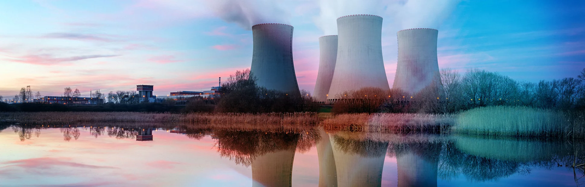 Nuclear power plant after sunset. Dusk landscape with big chimneys.