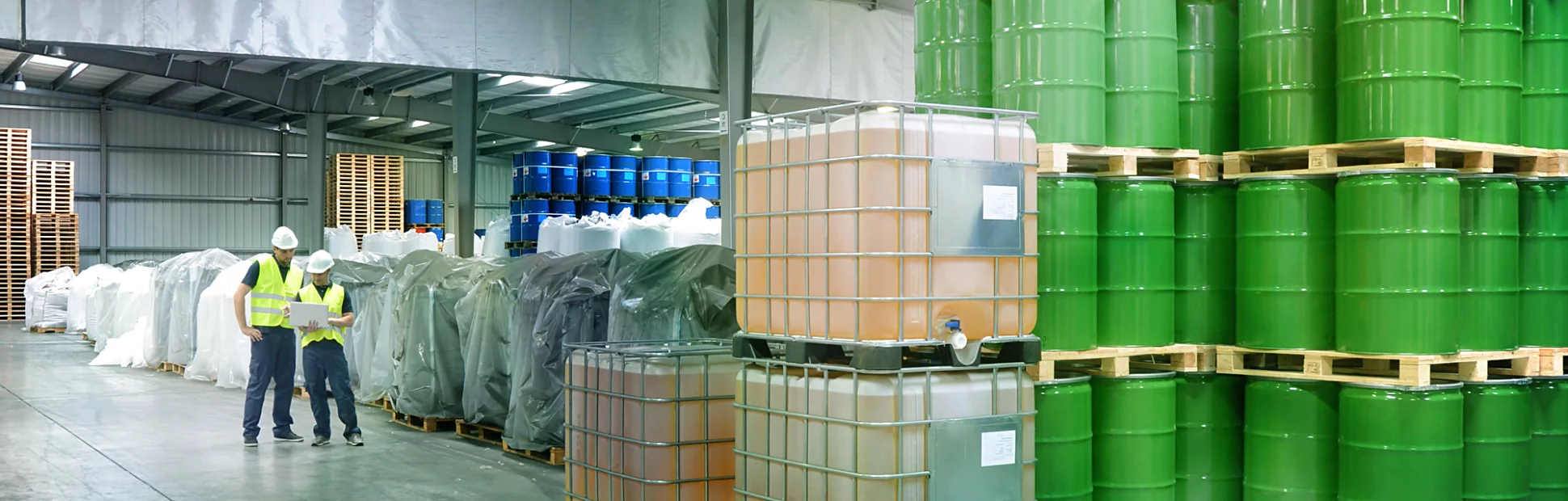 group of workers in the logistics industry work in a warehouse with chemicals