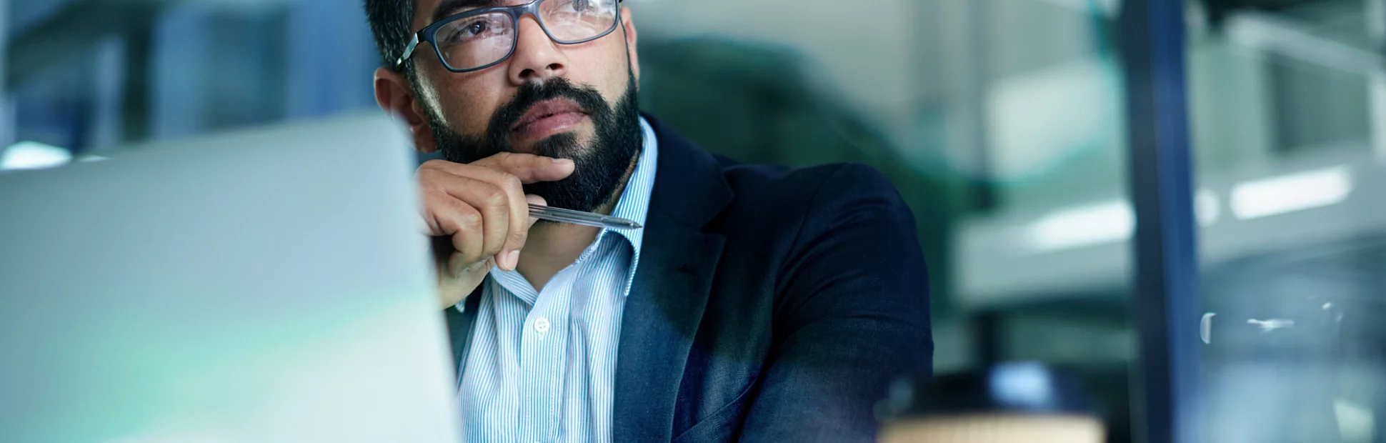 Shot of a mature businessman looking thoughtful while working on a laptop in an office
