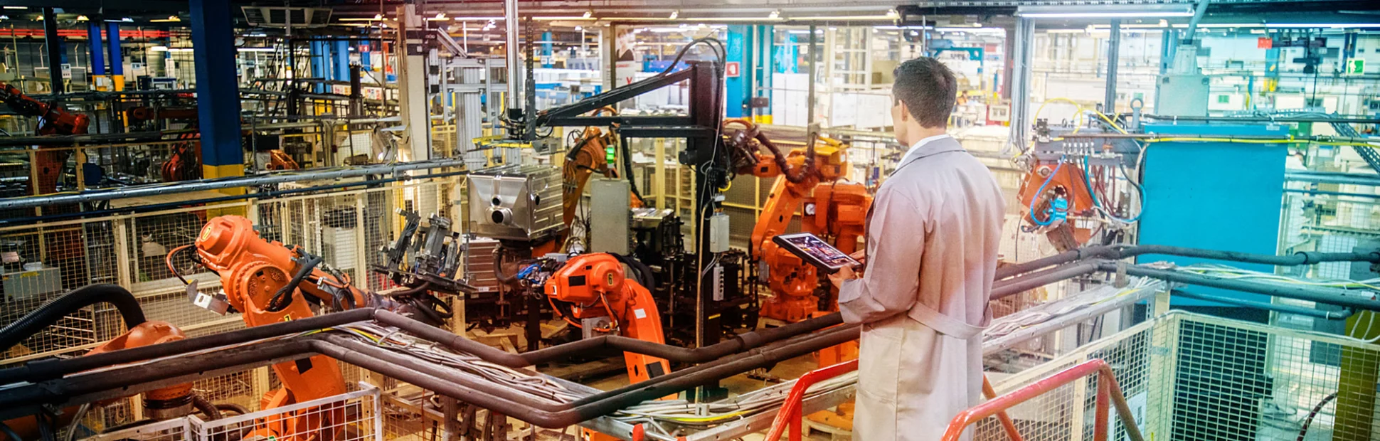 factory engineer inspecting work process robots operations in appliance manufacturing factory.