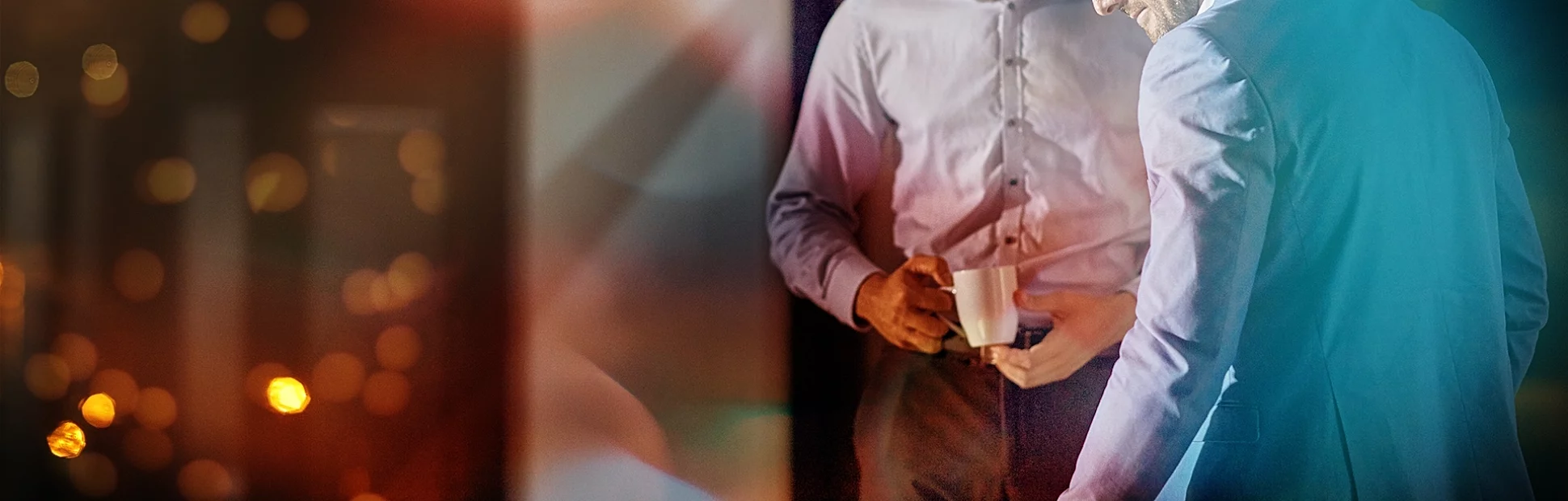 Shot of a coworkers using a laptop together while working late at the office