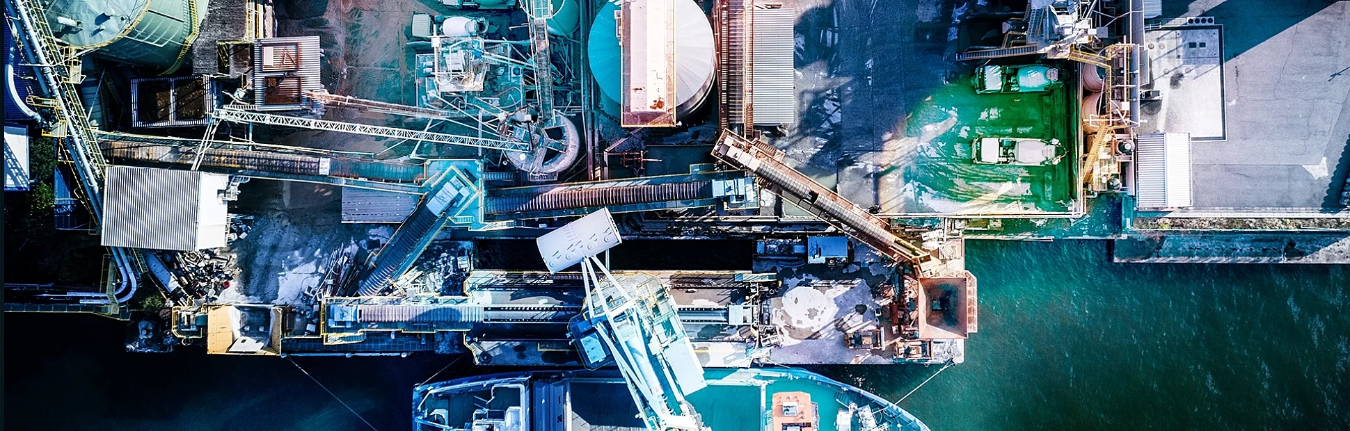Oil refinery storage units with tanker ships stock photo. Aerial view from directly above.