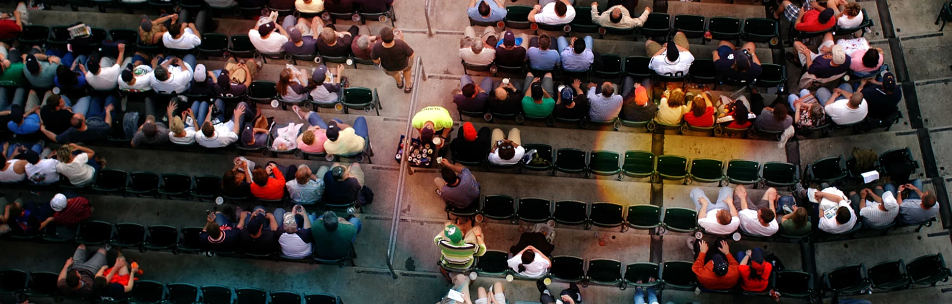 Shot from above a crowd watching a baseball game.