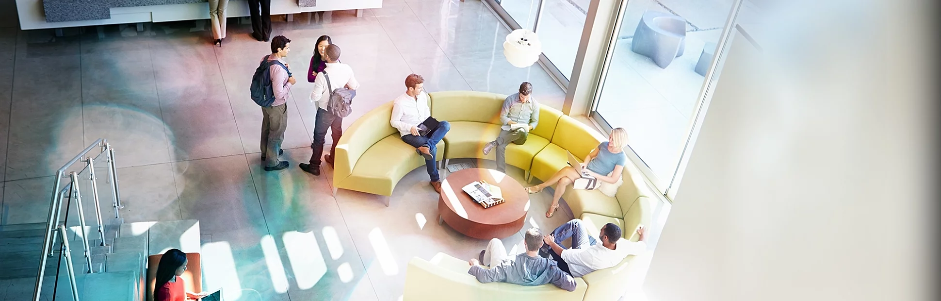 Reception Area Of Modern Office Building With People In Smart/Casual Dresswear