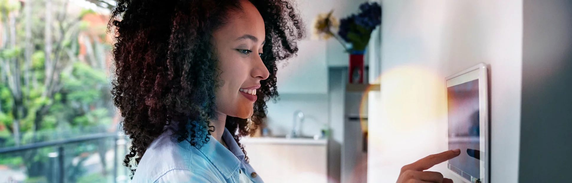 woman setting up the intelligent home system on a tablet computer - technology concepts