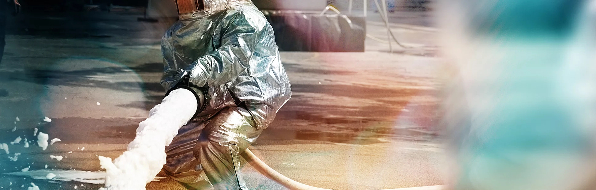 Save Download Preview Firefighter in action spraying fire with firefighting foam