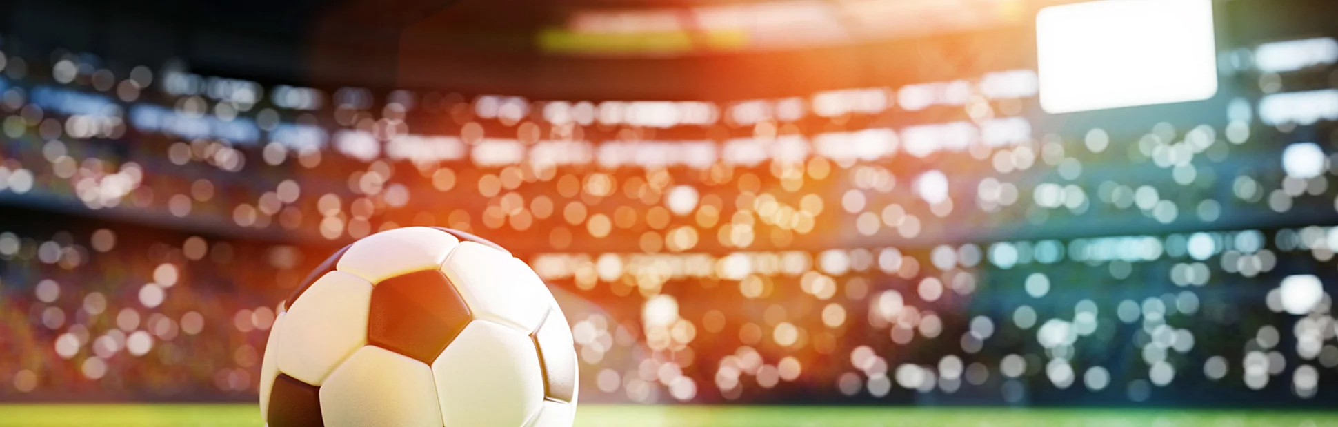 Football soccer ball on grass field on stadium.