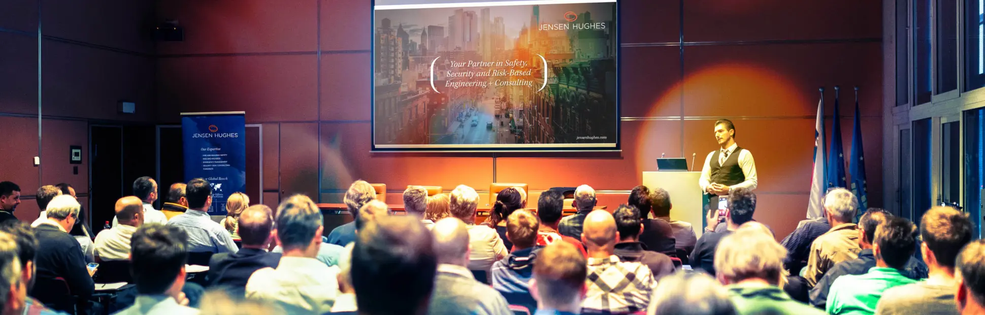 Speaker giving a talk in conference hall at business meeting event.