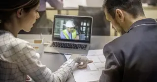 Two architects having video conference with an engineer colleague.