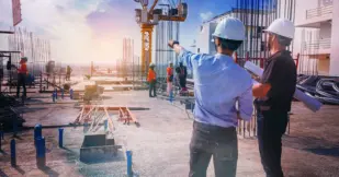 civil architect engineer inspecting and working outdoors structure building site with blueprints.