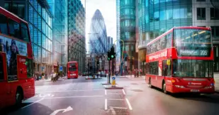 View of Street with Red Double Decker Buses, Gherkin skyscraper in the background.