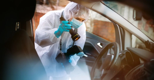 Person in PPE conducting a forensic investigation