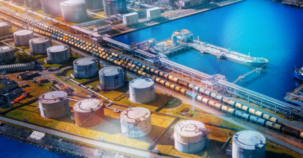 Aerial view large port oil loading terminal with large storage tanks and a railway