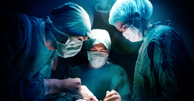 Surgical team working on a patient in operating theater