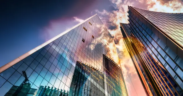 Bottom view of modern skyscrapers in business district in beautiful evening light at sunset