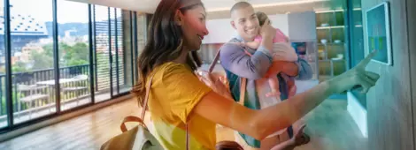 Happy family leaving the house locking the door using automated security system - smart home