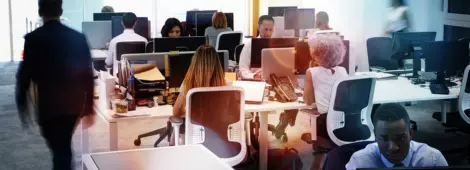 Man walking through a busy open plan office