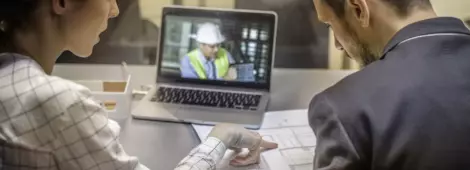Two architects having video conference with an engineer colleague.