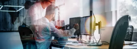View of two employees in formal clothes working in the office.