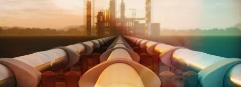 Steel oil pipes from refinery in the desert during sunset.