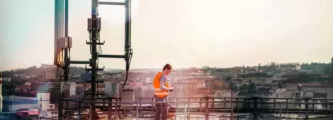 Telecommunication engineer repairing communication antenna on the top of chimney.