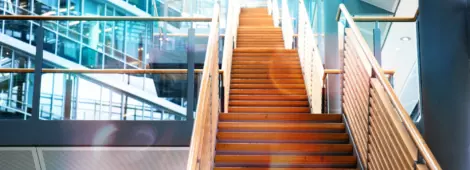 A wooden staircase in a modern office building