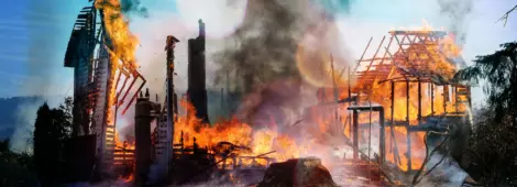 Old farm house completely consumed by fire is burnt to the ground.
