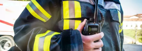 Firefighter using a walkie talkie, emergency call; all logos removed.