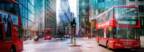 View of Street with Red Double Decker Buses, Gherkin skyscraper in the background.