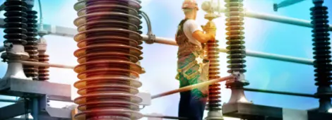 Construction worker with hadhat, protective workwear and safety belt working in power plant.