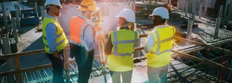 Construction Worker Using Instrument for Measuring Angles s on Construction Site.