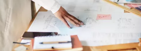 hand on an architectural blueprint