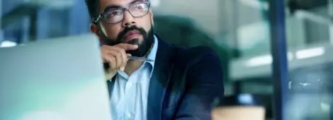Shot of a mature businessman looking thoughtful while working on a laptop in an office