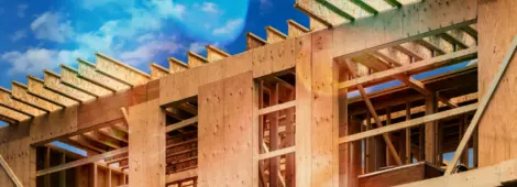 Plywood sheathing and engineered wood joists/rafters forming the roof of a house under construction