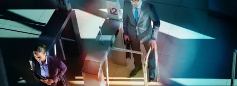 business people passing turnstile on the way to work