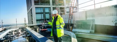 Architect inspects work at building site.