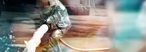 Save Download Preview Firefighter in action spraying fire with firefighting foam