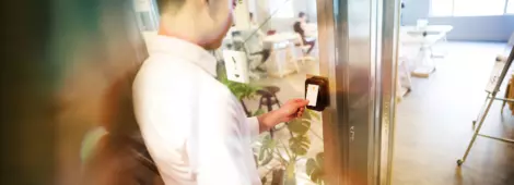 Man using his security badge to gain access to a room