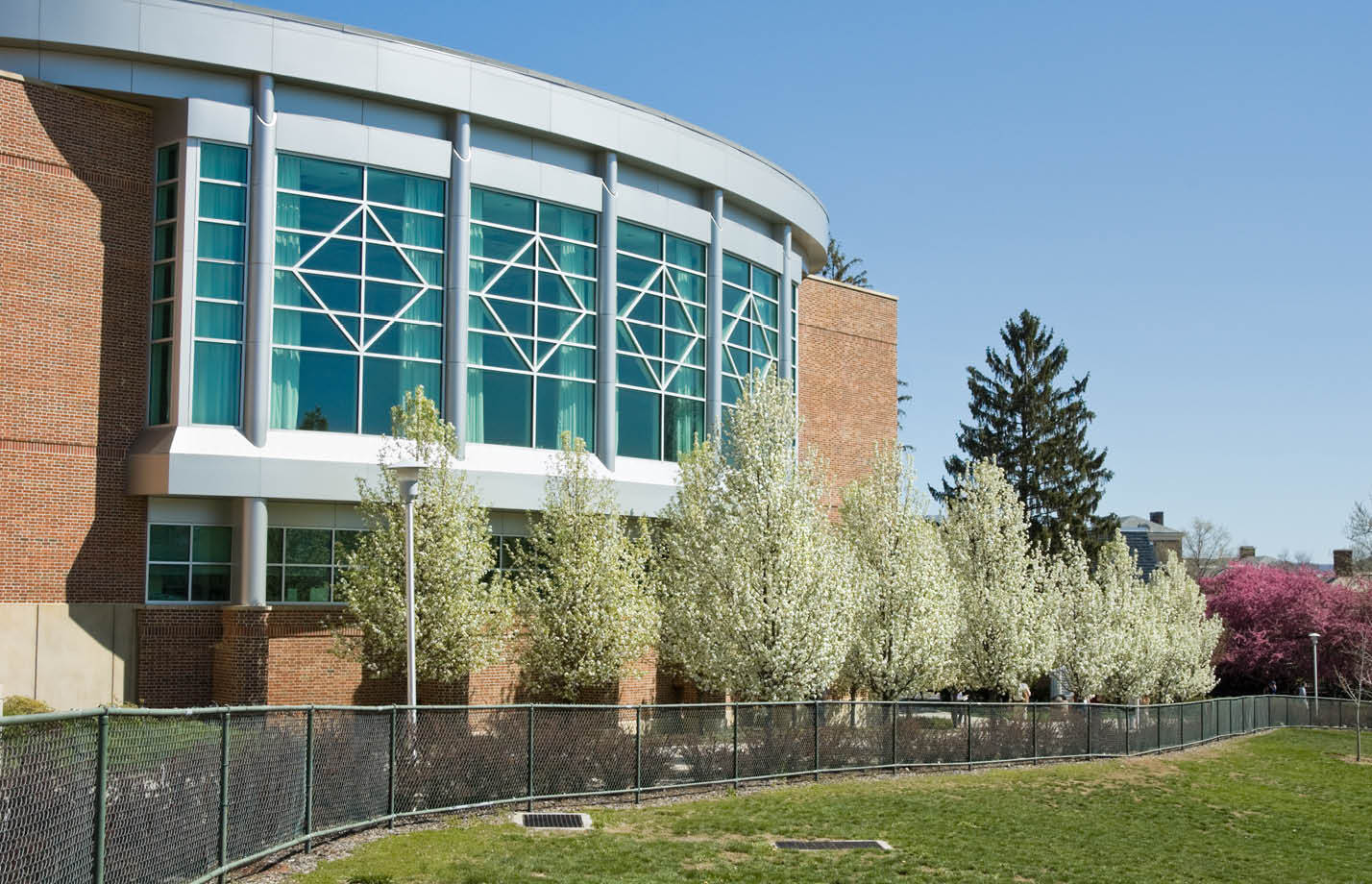 Penn State University educational building with trees planted in front