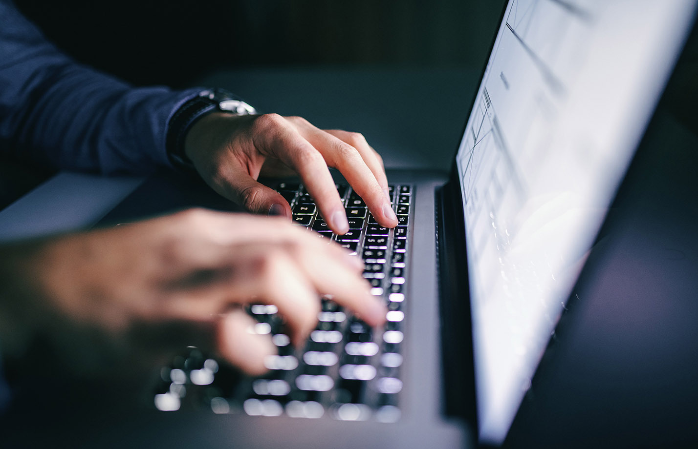 Close up of hands typing on laptop