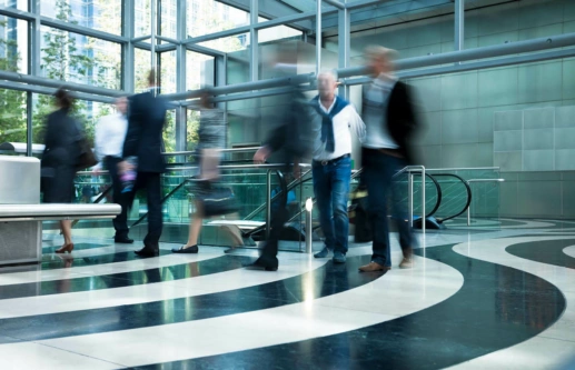 Busy pedestrian area in front of escalators in an office building