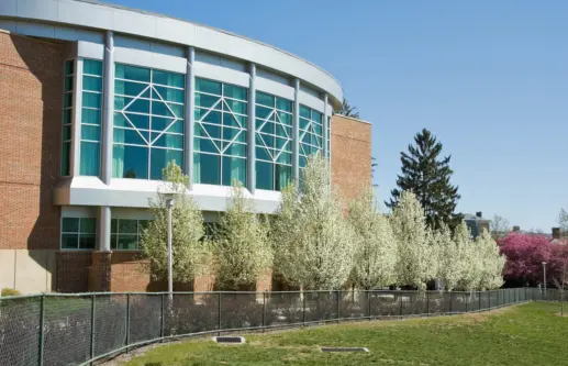 Penn State University educational building with trees planted in front