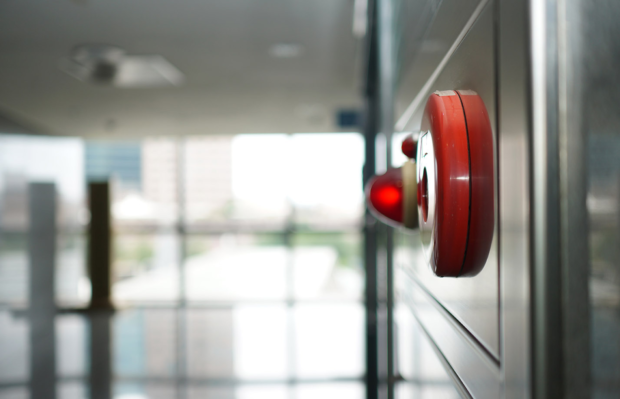 red fire alarm mounted on wall