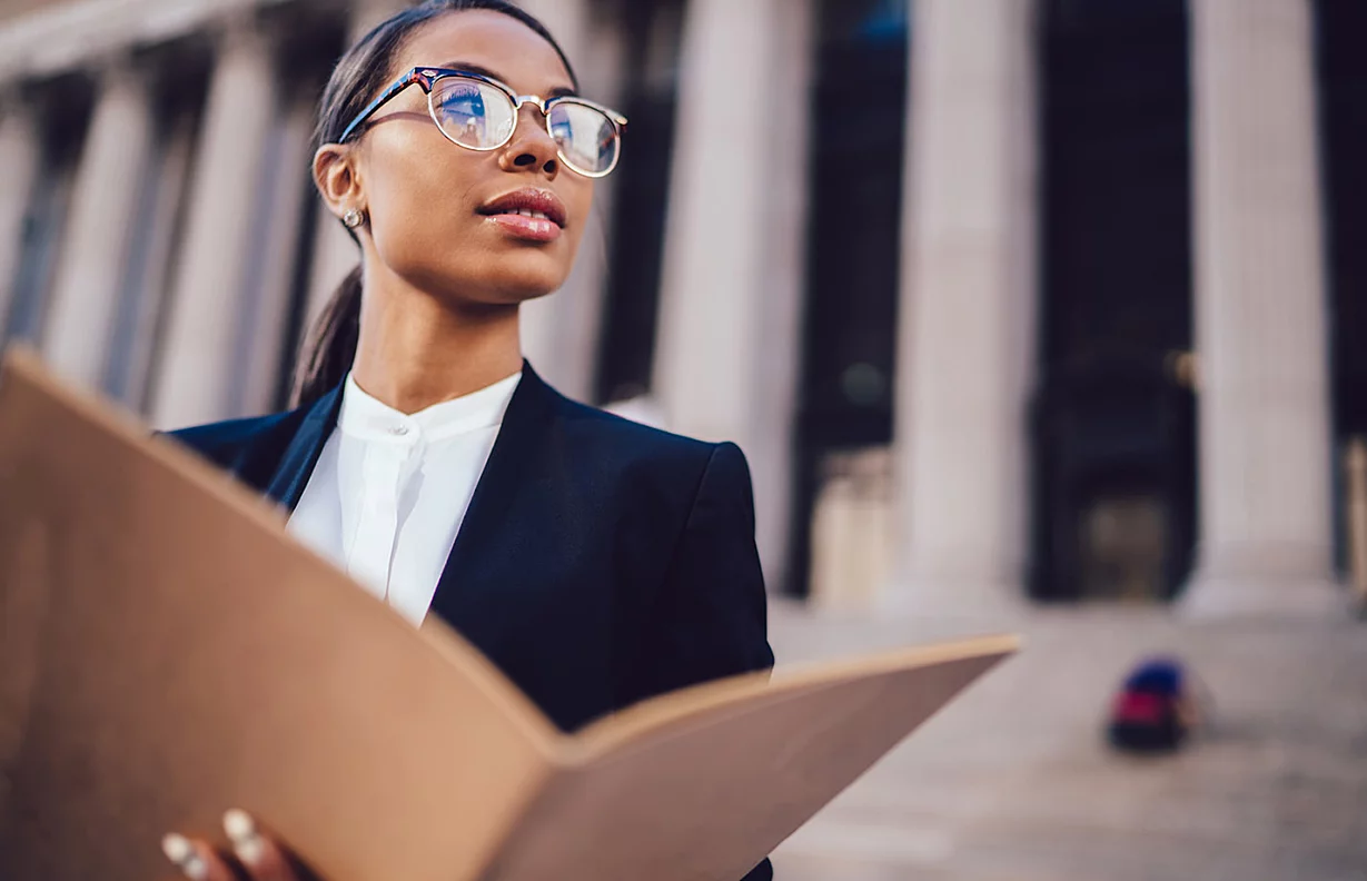 Young female lawyer in front of a courthouse