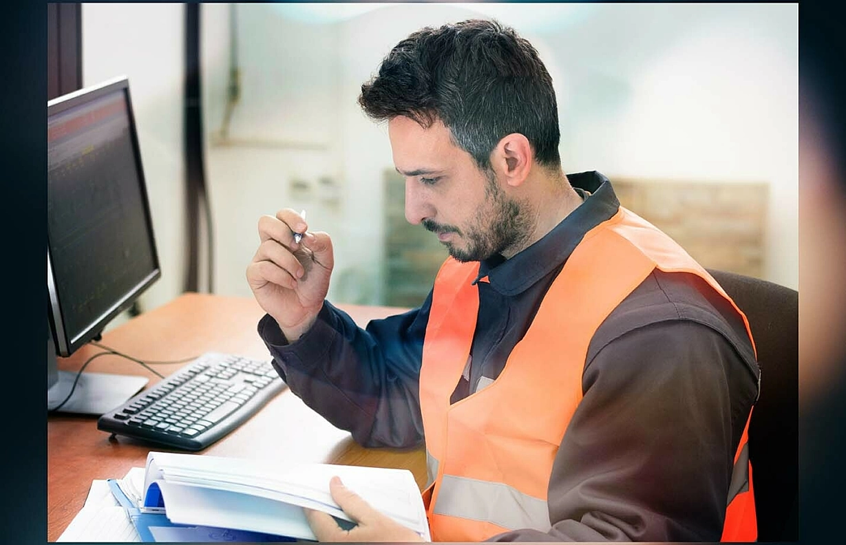Young male working writing or reviewing paperwork